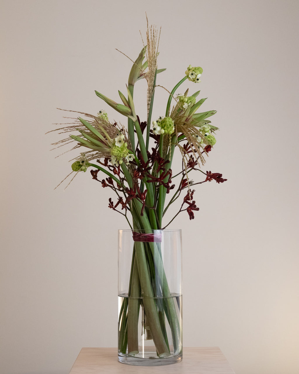 Large sculptural winter bouquet with bold silhouettes and layered seasonal flowers in deep winter tones.