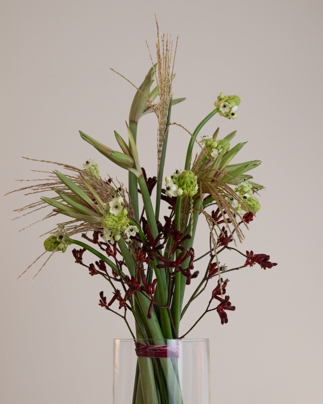 Large sculptural winter bouquet with bold silhouettes and layered seasonal flowers in deep winter tones.